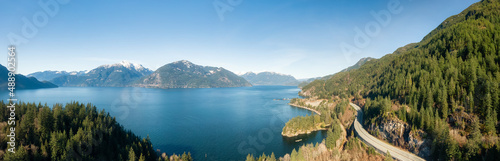 Aerial Panoramic View of Sea to Sky Highway on Pacific Ocean West Coast. Sunny Winter Day. Located in Howe Sound between Vancouver and Squamish, British Columbia, Canada.