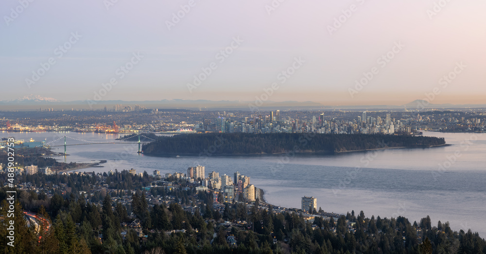 Panoramic View of Downtown Vancouver Cityscape, Stanley Park, Lions Gate Bridge and Burrard Inlet. Modern City on Pacific Ocean West Coast. Winter Sunset. British Columbia, Canada. Panoramic View of Downtown Vancouver Cityscape, Stanley Park, Lions Gate Bridge and Burrard Inlet. Modern City on Pacific Ocean West Coast. Winter Sunset. British Columbia, Canada.