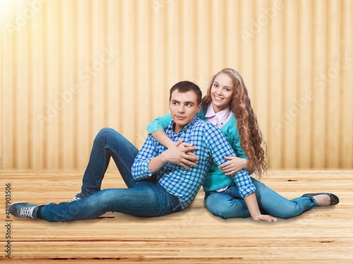 Carefree millennial man and woman. Young couple offering place for cool advertisement,