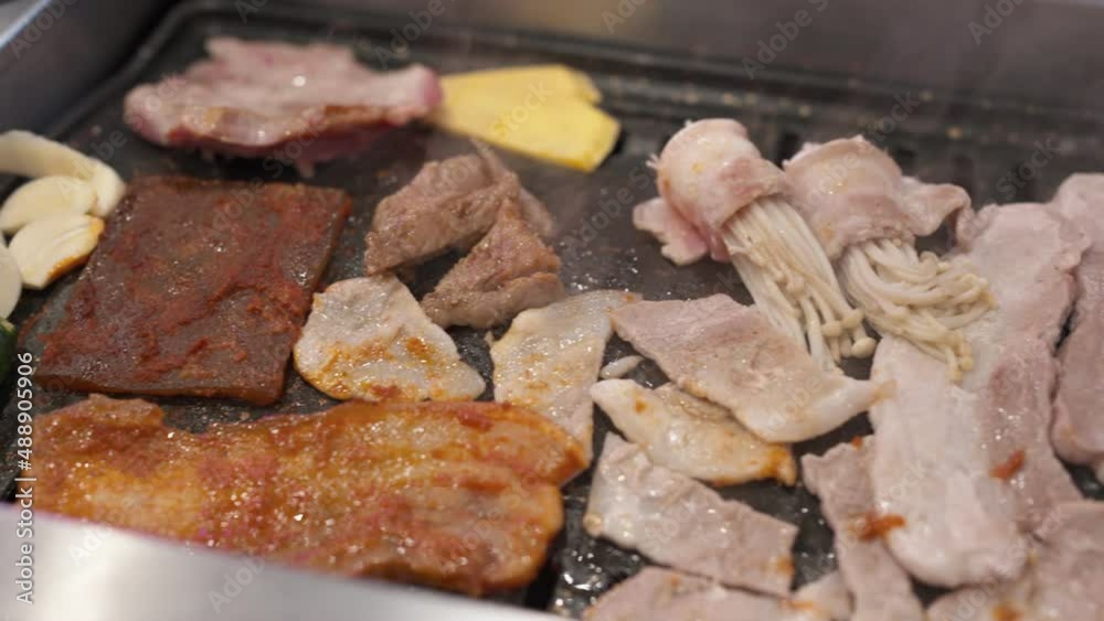 Korean barbecue buffet grilling pork meat and vegetable on gas stove Korean barbecue buffet grilling pork meat and vegetable on gas stove