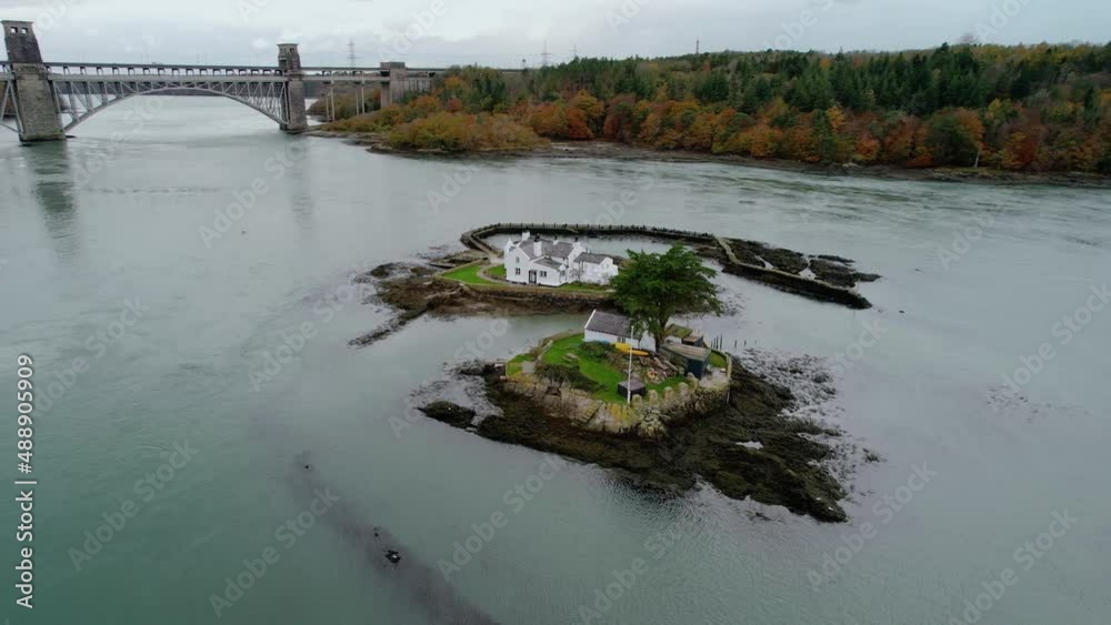 Aerial view Ynys Gored Goch houses on Whitebait island Welsh flowing Menai Straits Anglesey orbit left Aerial view Ynys Gored Goch houses on Whitebait island Welsh flowing Menai Straits Anglesey orbit left