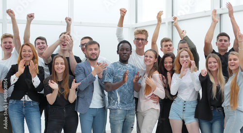 team of happy young people showing their success