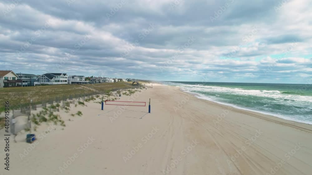 Low aerial view moving backwards over empty Long Beach Island NJ coast, 4K Low aerial view moving backwards over empty Long Beach Island NJ coast, 4K