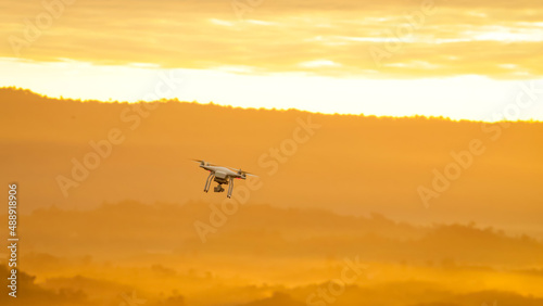 flying drone on mountain at beautiful sunrise