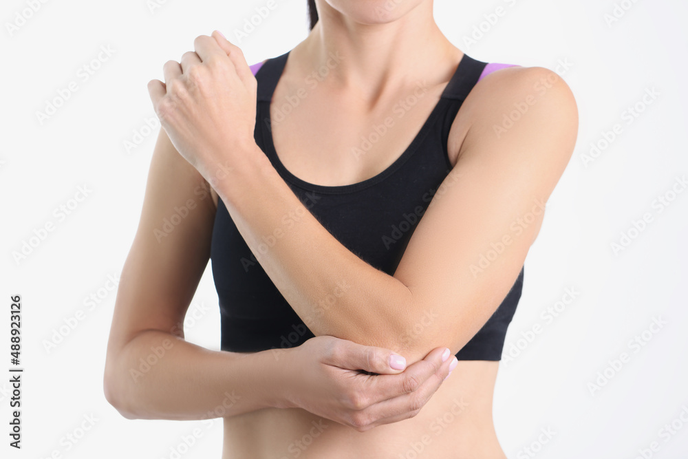 Young woman in top with elbow pain closeup
