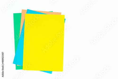 Colorful paper on white. Copy space