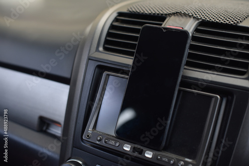 Mobile phone placed on the dashboard of the car