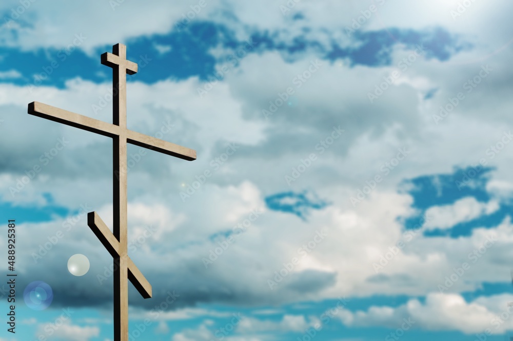 Dramatic religious church cross framed against a moody sky