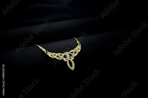 A closeup of a gold Jewellery with black background