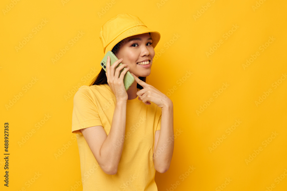 Charming young Asian woman holding a phone posing lifestyle technology studio model unaltered Charming young Asian woman holding a phone posing lifestyle technology studio model unaltered