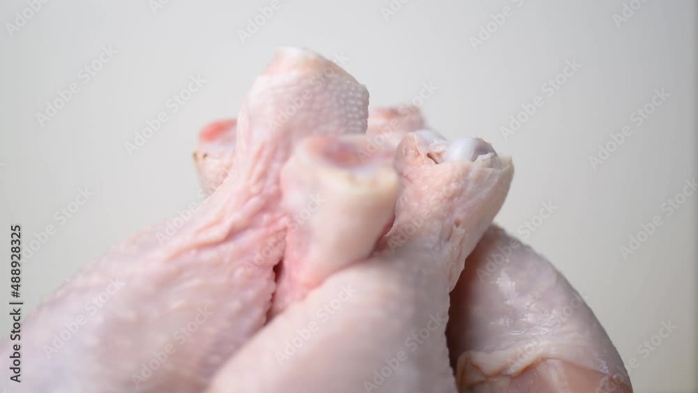 Raw, fresh chicken thigh, spinning in a circle on a chopping board. Raw, fresh chicken thigh, spinning in a circle on a chopping board.