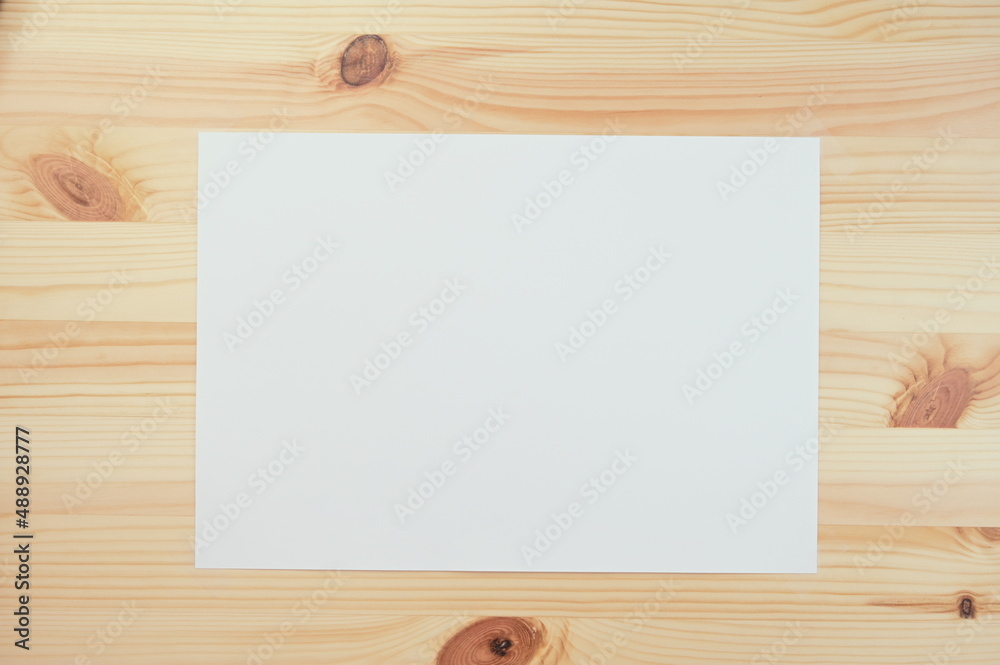white paper on wood table white paper on wood table