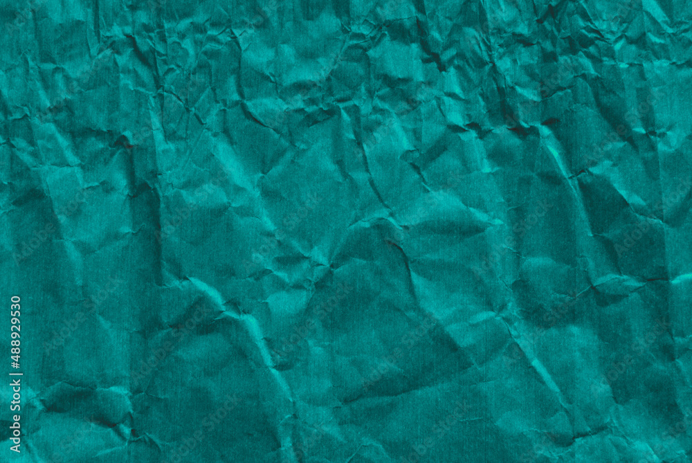 Green wrinkled paper texture as background Green wrinkled paper texture as background