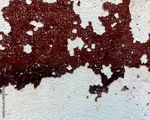 The old paint on the concrete wall peeled off like a map of the world. abstarct background and tecture.Old concrete wall exterior .