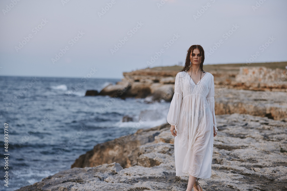 woman traveler in white dress at the sea beach Lifestyle unaltered