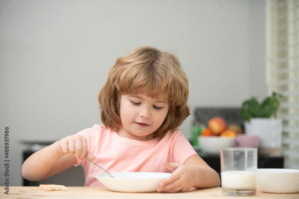 Child eating healthy food. Cute little boy having soup for lunch. Child eating healthy food. Cute little boy having soup for lunch.