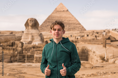 Man tourist walks background of pyramids in Giza Cairo Egypt, sun light travel banner.