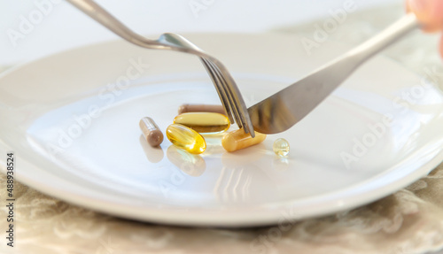 Supplements and vitamins on a plate. Selective focus.