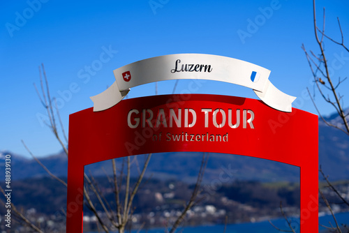 Photography Aerial view through red metal frame of Grand Tour Switzerland from local mountain Gütsch over the City of Luzern on a sunny winter day