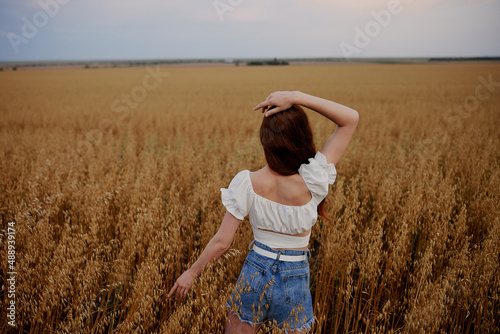Fototapeta Naklejka Na Ścianę i Meble -  woman walking in the field landscape freedom back view