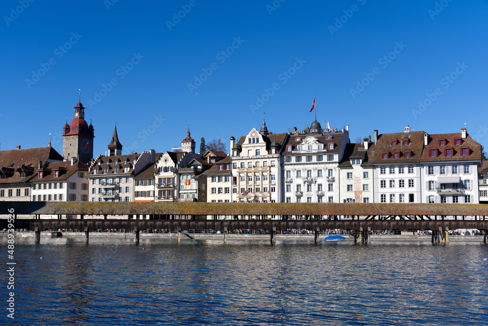 Medieval old town of Luzern with famous covered wooden Chapel Bridge (German: Kapellbrücke) and stone water tower on a sunny winter day. Photo taken February 9th, 2022, Lucerne, Switzerland.