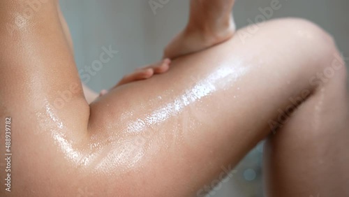 Woman washing her legs in the shower. photo