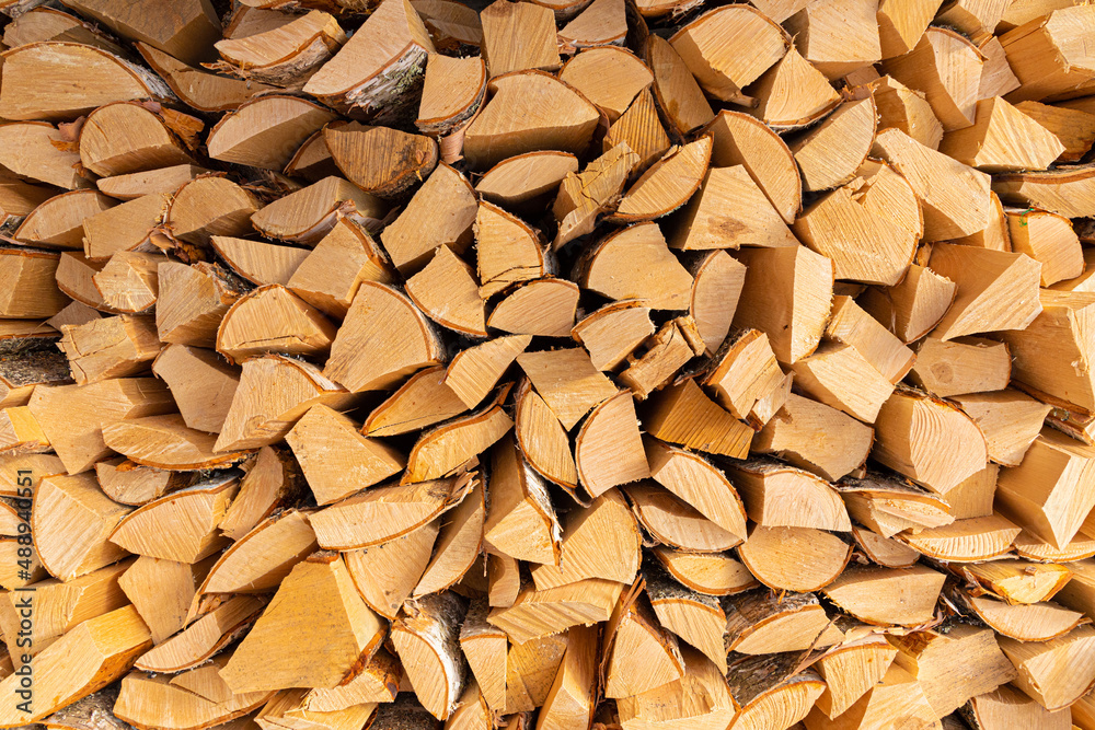 Beautiful background, backdrop or texture of vivid, bright and colorful heap or stack of wood or firewood on the sunny day Beautiful background, backdrop or texture of vivid, bright and colorful heap or stack of wood or firewood on the sunny day