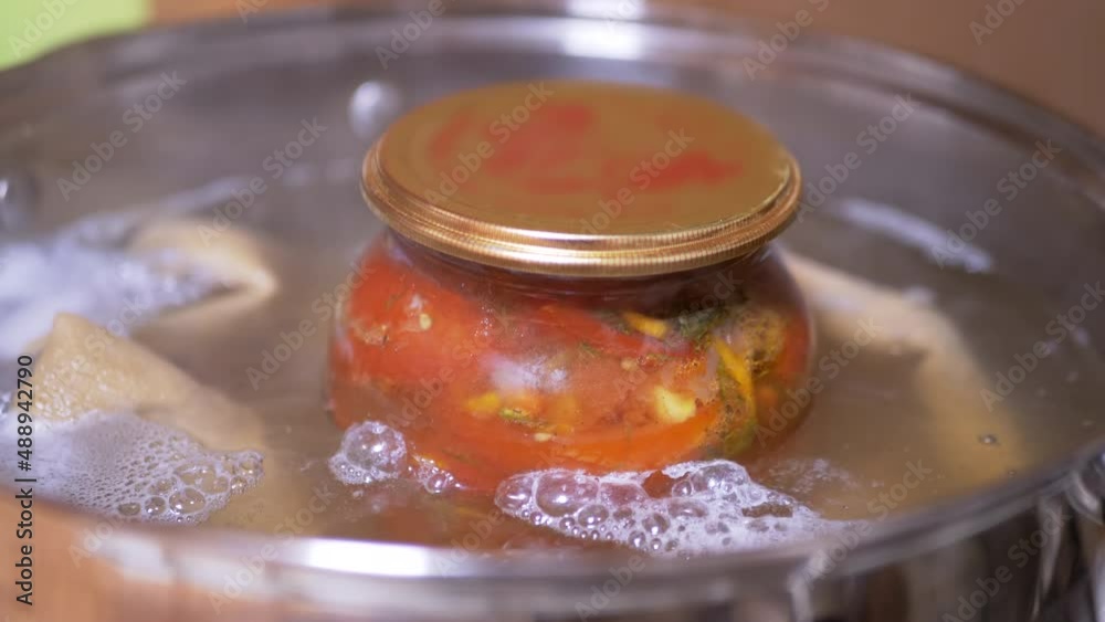 Process of Sterilizing a Jar of Pickled Tomatoes in a Saucepan of