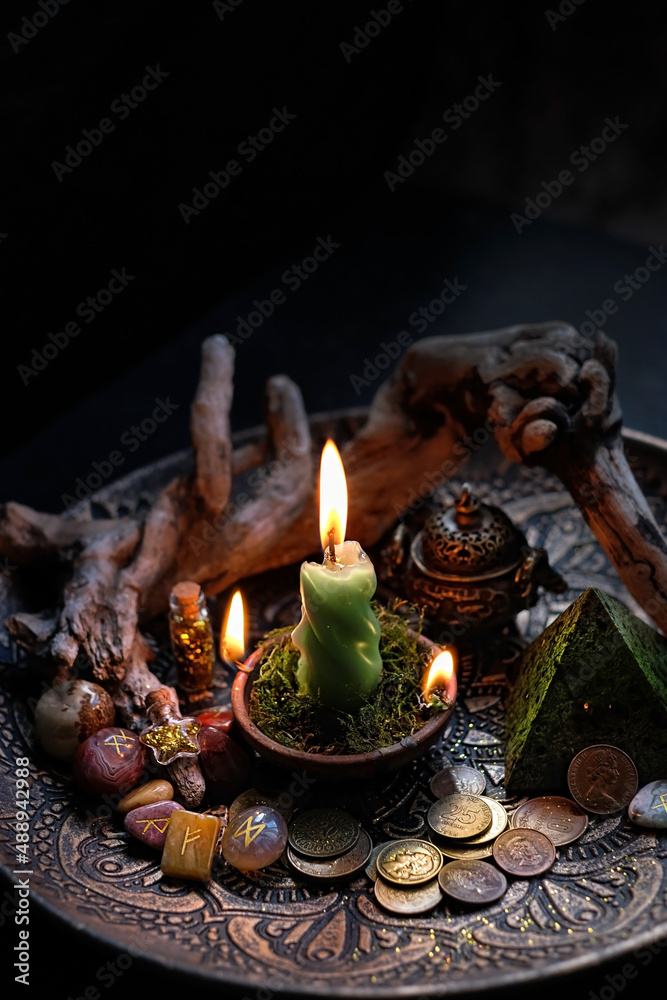 Witch altar with candles, different old coins, stone runes, crystals on dark table background close up. Magic for attracting money, wealth. witchcraft money esoteric ritual. occultism concept Witch altar with candles, different old coins, stone runes, crystals on dark table background close up. Magic for attracting money, wealth. witchcraft money esoteric ritual. occultism concept
