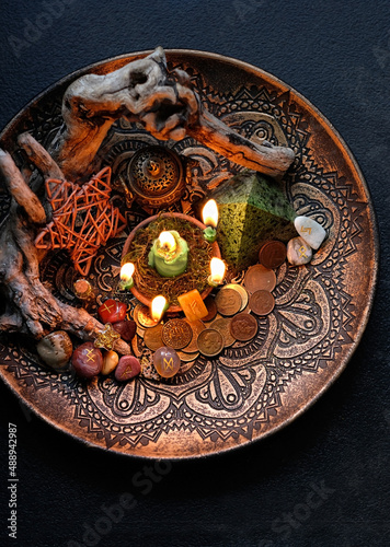Witch altar with candles, different old coins, stone runes, pentacle on dark table background. Magic for attracting money, wealth. witchcraft money esoteric ritual. occultism concept. top view