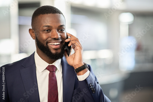 African american entrepreneur having phone conversation, closeup photo
