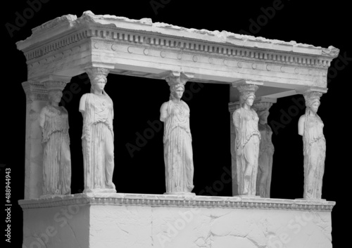 The Caryatid porch of the Erechtheion Temple in Athens isolated on black background with clipping path photo