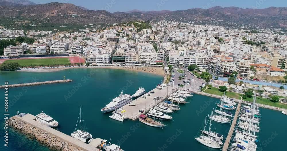 drone shot over the marina, seaside boulevard, beaches, summer in Agios Nikolaos Crete Greece drone shot over the marina, seaside boulevard, beaches, summer in Agios Nikolaos Crete Greece