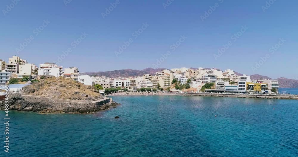 Drone shot over the marina, seaside boulevard, beaches, summer in Agios Nikolaos Crete Greece Drone shot over the marina, seaside boulevard, beaches, summer in Agios Nikolaos Crete Greece