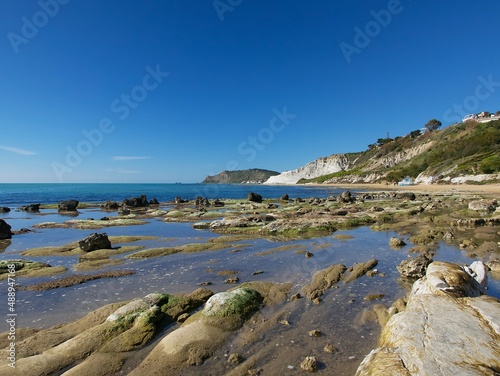 view of the beach in Realmonte, Agrigento against the blue sky on a clear sunny day, Sicily © in_colors
