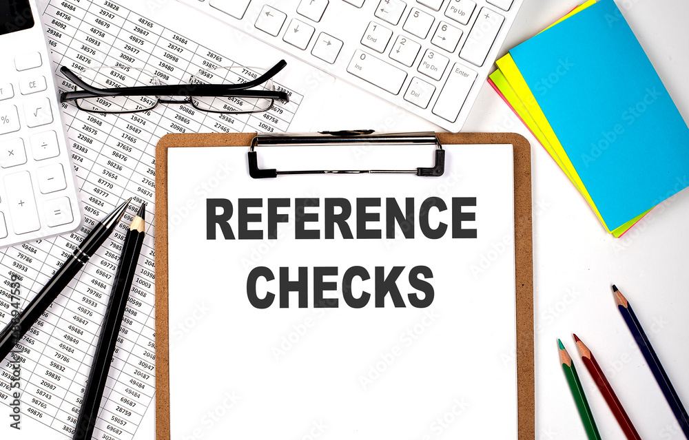 Clipboard with text REFERENCE CHECKS and keyboard and chart on white background. Clipboard with text REFERENCE CHECKS and keyboard and chart on white background.