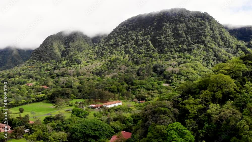 Approaching crater wall mountain of an extinct volcano in Valle de Anton central Panama with ranches below, Aerial approach shot Approaching crater wall mountain of an extinct volcano in Valle de Anton central Panama with ranches below, Aerial approach shot