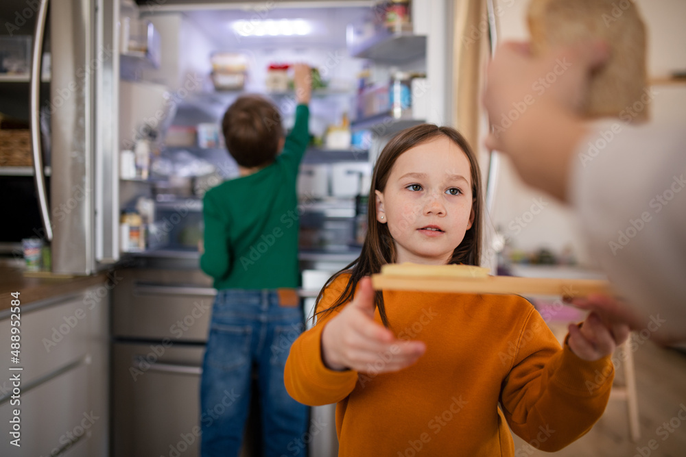 Little chidlren helping mother in kitchen at home. Little chidlren helping mother in kitchen at home.