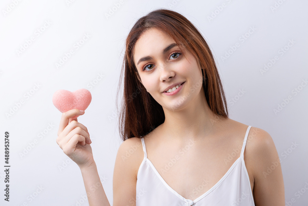 Beautiful smiling woman with clean skin, natural make-up and white teeth on a gray background Beautiful smiling woman with clean skin, natural make-up and white teeth on a gray background