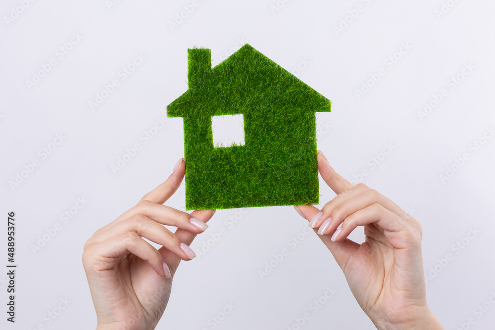 Female hands hold a model of a green house close-up. Sale of ecological real estate of the future. Female hands hold a model of a green house close-up. Sale of ecological real estate of the future.