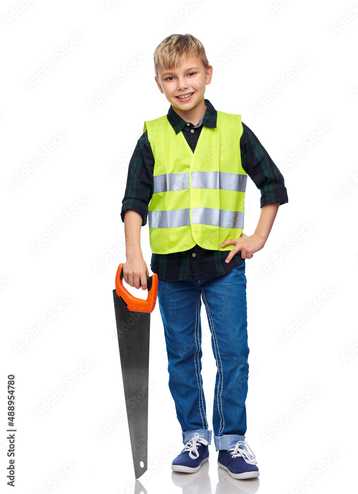 building, carpentry and profession concept - happy smiling little boy in protective helmet and safety vest with saw over white background building, carpentry and profession concept - happy smiling little boy in protective helmet and safety vest with saw over white background