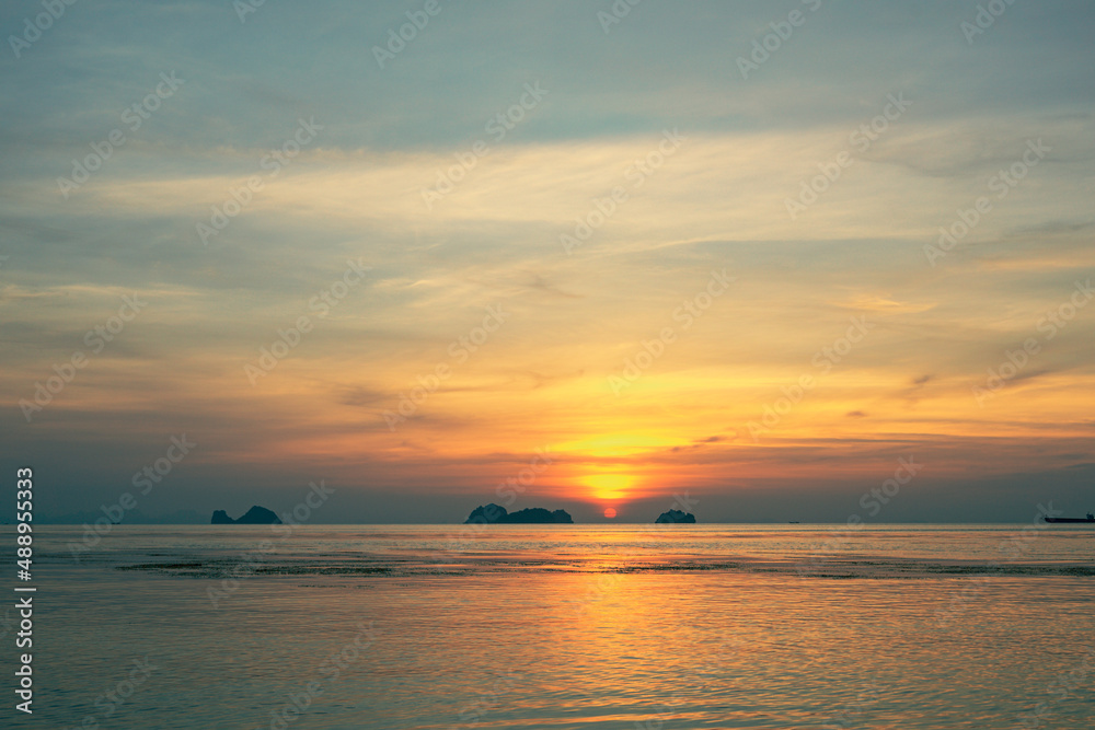 Spectacular colorful sunset over sea and islands on a summer evening. Sun setting in the sea.