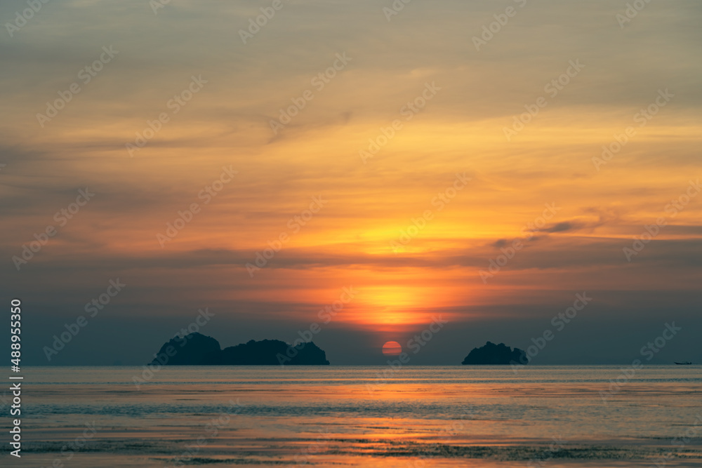 Spectacular colorful sunset over sea and islands on a summer evening. Sun setting in the sea.