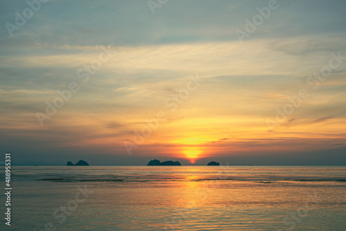 Spectacular colorful sunset over sea and islands on a summer evening. Sun setting in the sea. © mizuno555