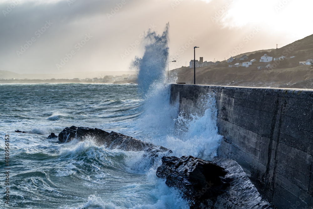 Waves crashing against the pier at Portnoo harbour after Storm Franklin - County Donegal, Republic of Ireland