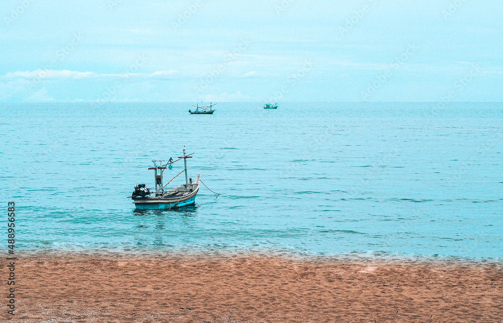 Beach  Andaman Sea, Thailand . Summer seascape with  beautiful beach warm sand and Old Wooden Boats  
