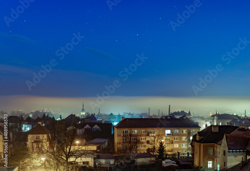 fog over the city at dawn.bright stars over glowing mist © Alesia