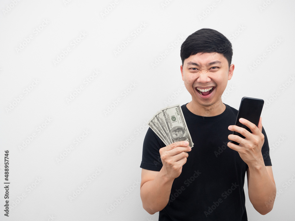 Man holding money and mobile phone feeling happy with copy space