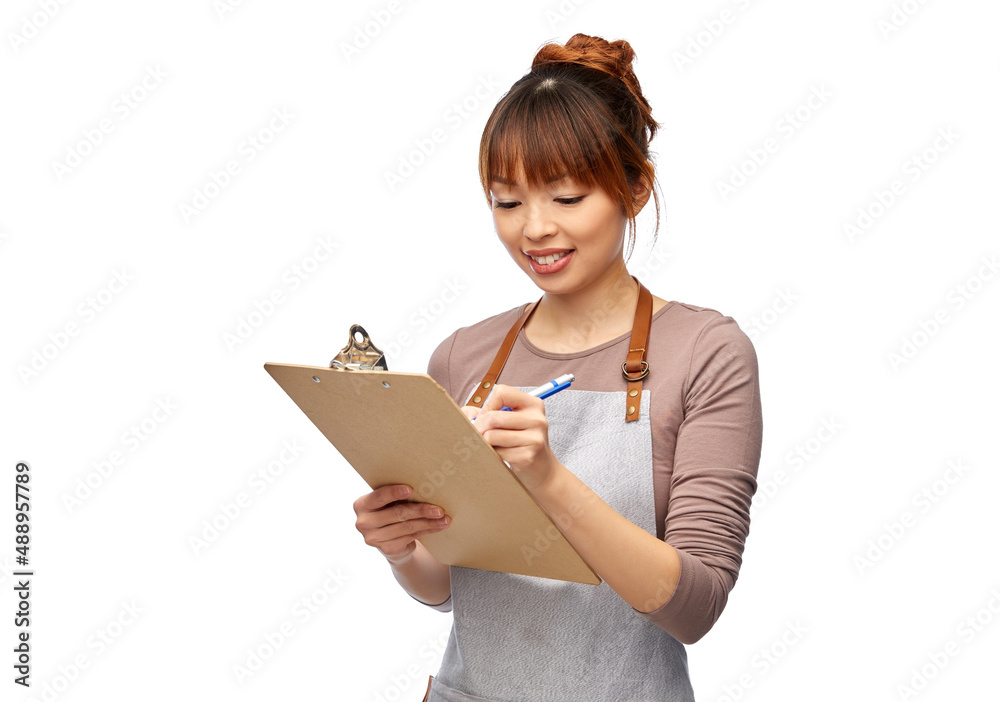 cooking, culinary and people concept - happy smiling female chef or waitress in apron with clipboard and pen writing over white background cooking, culinary and people concept - happy smiling female chef or waitress in apron with clipboard and pen writing over white background