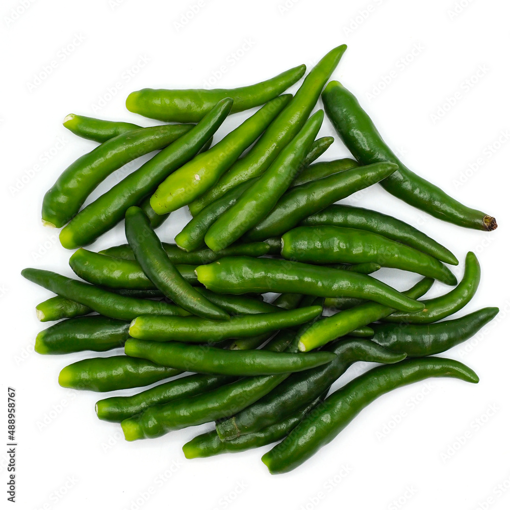 A pile of green chili pepper without stalk chili pole on white background. spot focus.